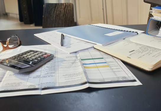 Desk with papers and calculator