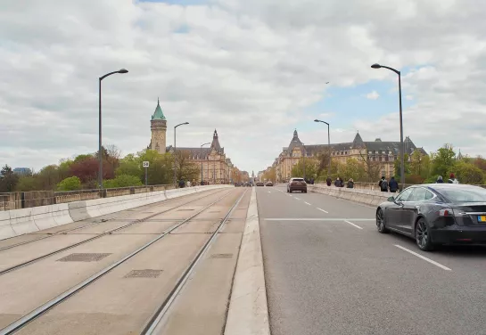 Road on Adolphe Bridge leading to Plateau Bourbon in Luxembourg City, with the Grand Ducal Palace in the background