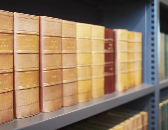 Close-up of law codes on a bookshelf in the library of Stibbe in Brussels