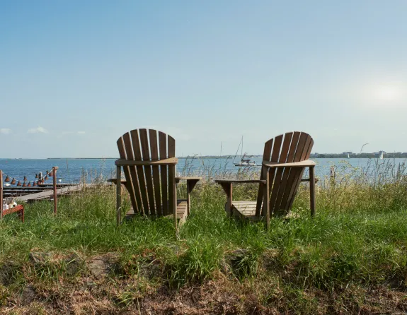 Adirondack chairs by the water